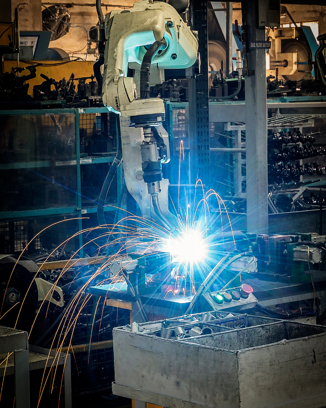 Robô industrial soldando com sparks
